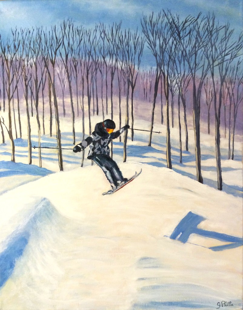 Garçon en gris et noir capté en plein saut à ski alpin 