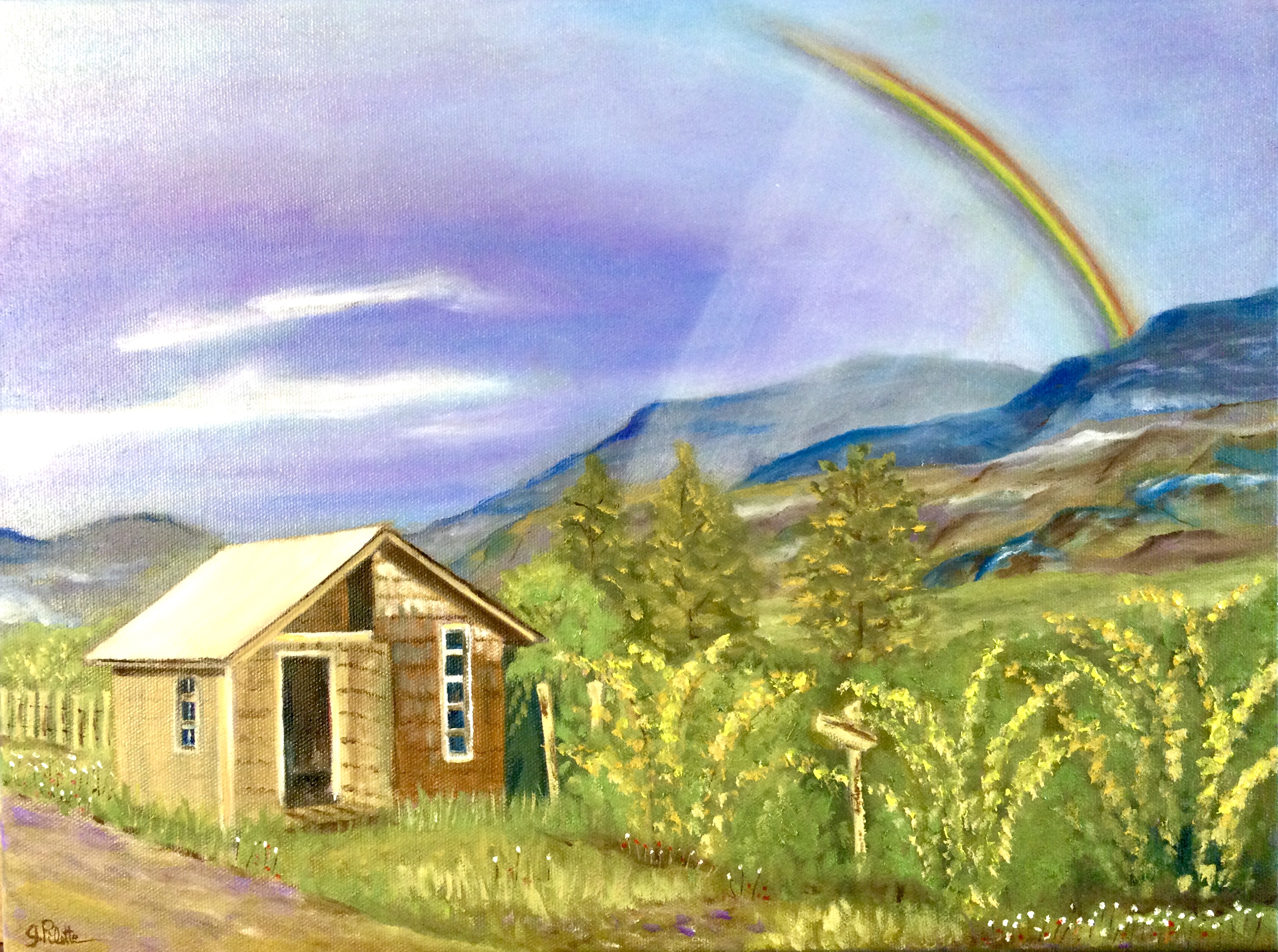 Petite maisonnette en bois près d’une montagne au Chili avec un arc-en-ciel au-dessus 