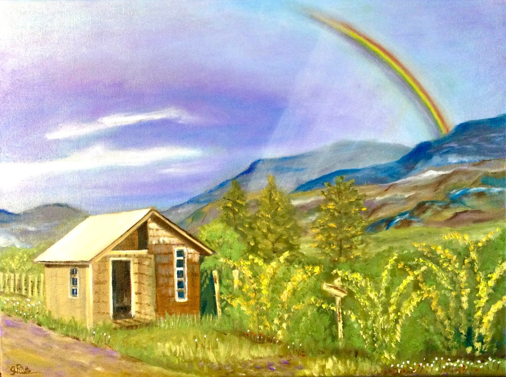 Petite maisonnette en bois près d’une montagne au Chili avec un arc-en-ciel au-dessus 